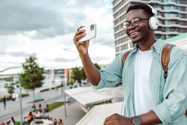 istock Young African-American man taking a selfie 1421984146