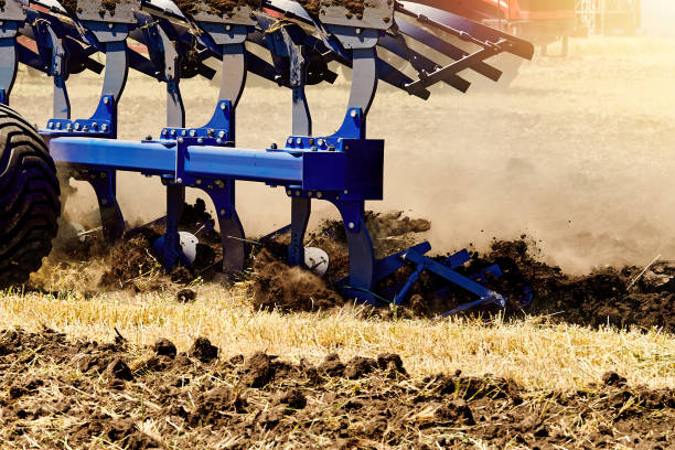 istock Tractor plows a piece of land in a field. 1421987482