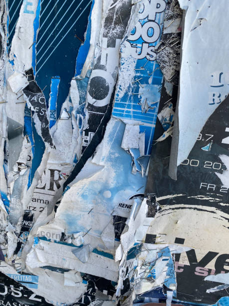 istock Close-up torn blue paper on wood with staples 1421988524