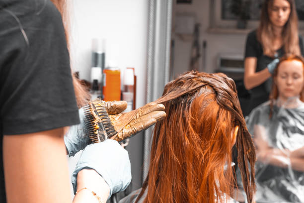 Hair Coloring In A Beauty Salon. Professional wizard paints the hair in the salon. Beauty concept, hair care. Hairdressing Services. stock photo