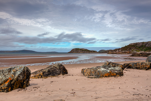 Gruinard Bay is a large remote coastal embayment, located 12 miles north of Poolewe. Gruinard Bay has three stunning, pink sand beaches from the Torridon rocks