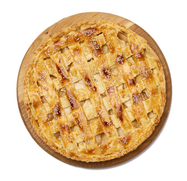 istock Round baked apple pie on a wooden board, white isolated background. 1421996711