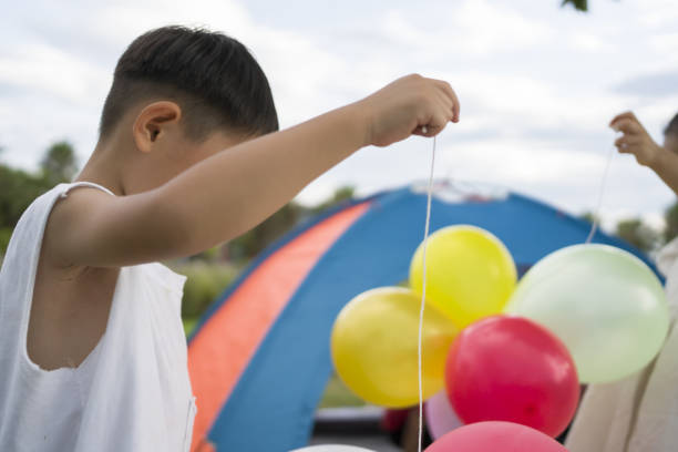 istock Asian kids camping outdoors 1421997083