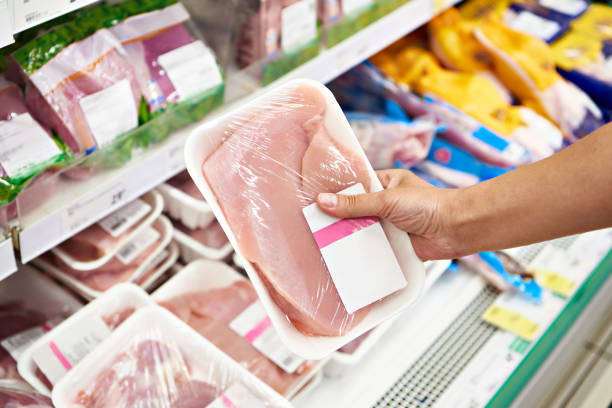istock Hands with turkey meat in shop 1422000726