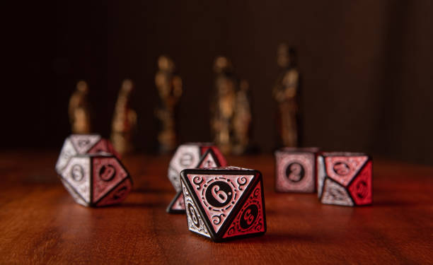 istock RPG dice, beautiful RPG dice on rustic wood, dark background with figures, selective focus. 1422001845