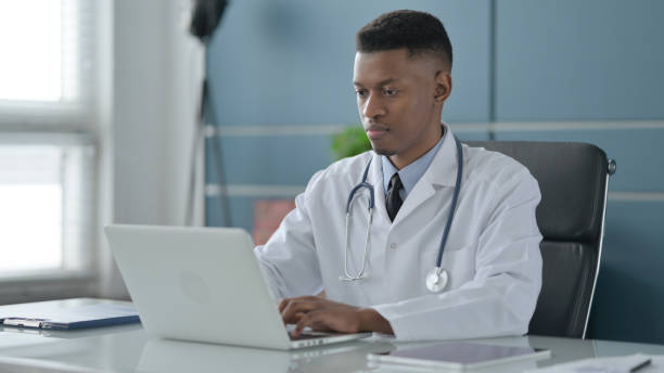 istock African Doctor Working on Laptop in Office 1422006803