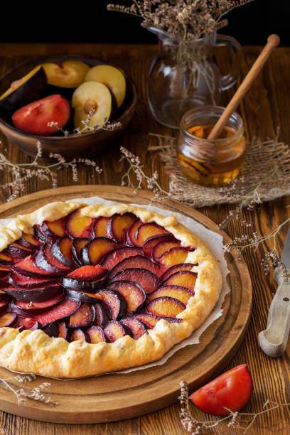 Plum Galette on wooden, close up Homemade organic healthy dessert - plum pie or french galette. stock photo