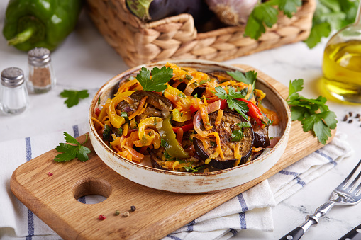 Vegetable salad with eggplant, sweet pepper, carrot, onion and parsley.  Savory taste. Vegetarian dish.
