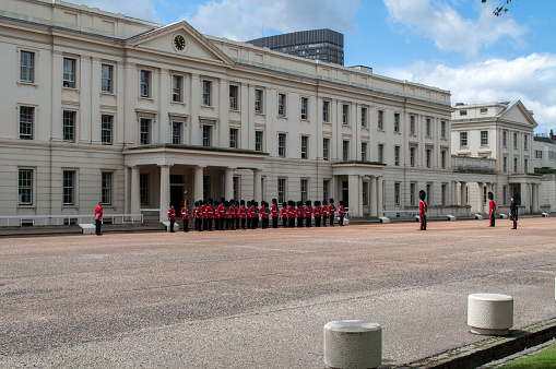 British royal soldiers in red uniforms are posted outside a barracks in central London.