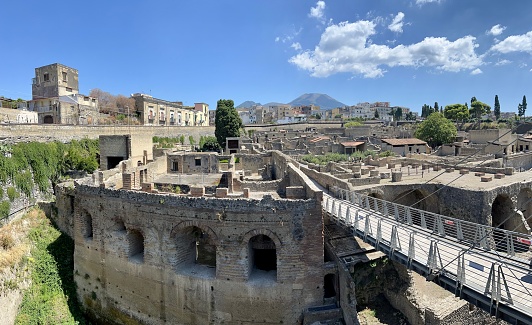 Entrance to Herculaneum Archaeological Park (Parco Archeologico di Ercolano) with Mt Vesuvius in the background on a very hot day