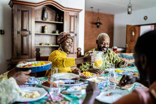 istock Young woman serving juice during lunch at home 1422024201