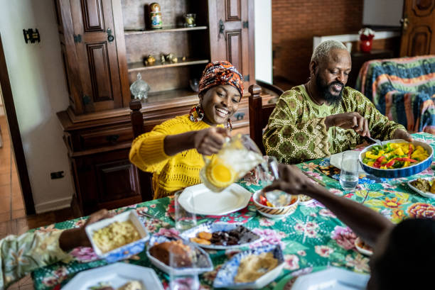 istock Young woman serving juice during lunch at home 1422024204
