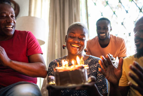 istock Family celebrating young woman's birthday 1422024832