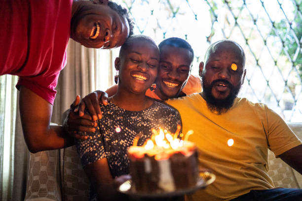 istock Family celebrating young woman's birthday 1422024869