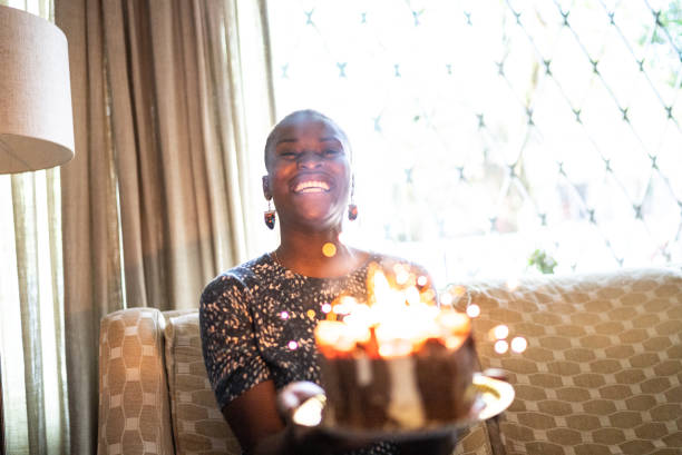 istock Happy young holding birthday cake 1422025002