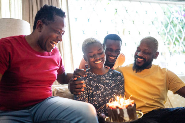 istock Family celebrating young woman's birthday 1422025512