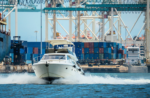 Boat speeding alongside at the Industrial port of Miami, Florida