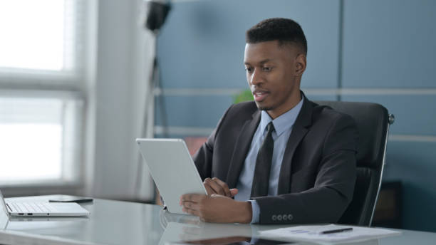 istock African Businessman making Video Call on Tablet in Office 1422028029