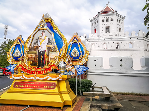 Bangkok, Thailand - September 10, 2019:  The ancient fortress Phra Sumen Fort (Pom Phra Sumen) with an altar to the king at the left