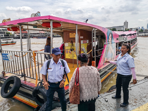 Bangkok, Thailand - September 10, 2019: passengers entering in a pink ferry boat on the Chaophraya River in Bangkok Thailand This picture shows people from Bangkok crossing the Chaophraya River with a ferry boat