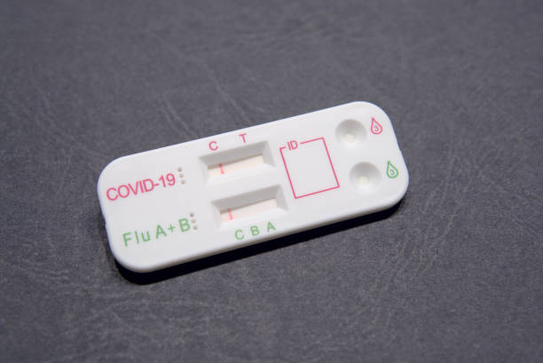 istock Dual combined home self test for coronavirus and flu A B virus. Antigen test in black background 1422029718