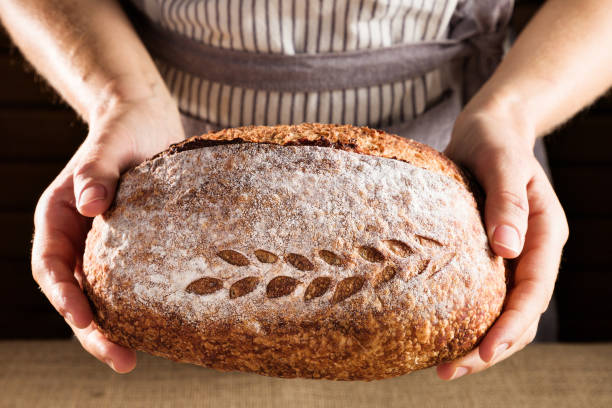 istock woman's hands holding a homemade bread 1422030441