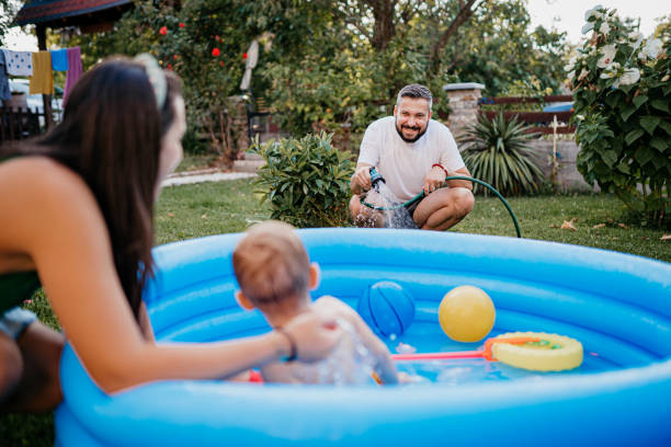 istock A woman sprays a hose in the yard 1422034722