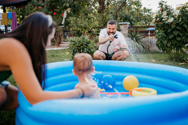 istock A woman sprays a hose in the yard 1422034838