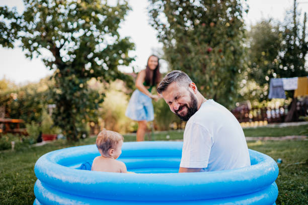 istock Dad and son in the pool 1422035070