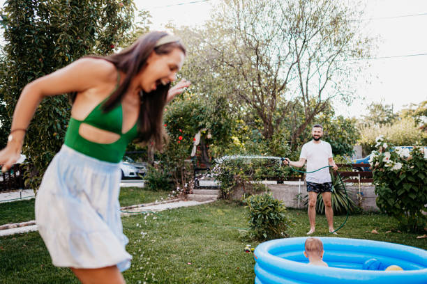 istock Spraying with a hose in the yard 1422035318