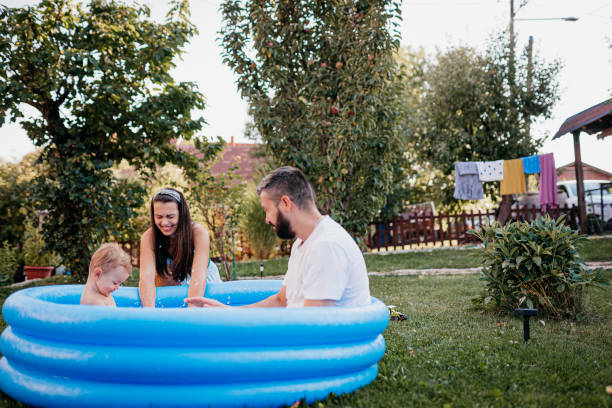 istock Mom and dad are playing with their son in the pool 1422035372