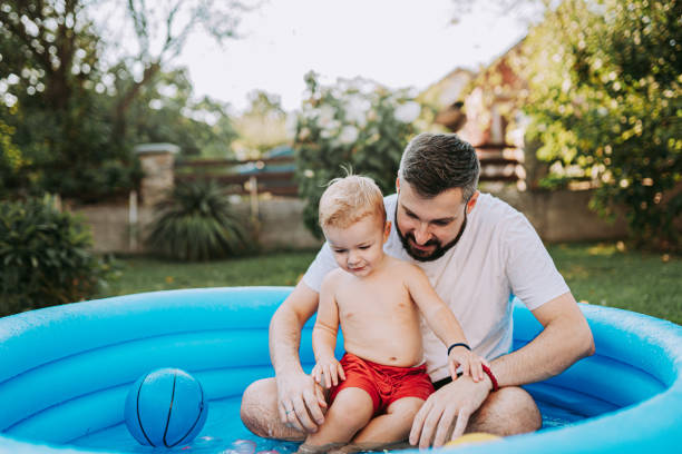 istock Dad is playing in the rubber pool with his son 1422035416