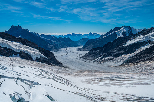 Rhone glacier on the top of the mountain with visible ice surface, snow and cracks. Scenic high alps mountains arid landscape.