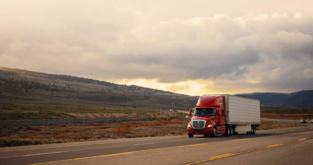 istock Semi-truck driving on empty single line road in Utah 1422036186