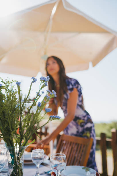 A woman sets the table for lunch