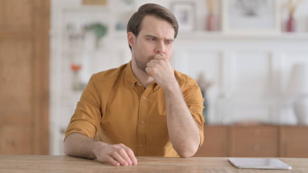 istock Pensive Young Man Thinking, Sitting in Office 1422043837