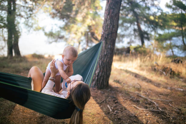 istock Baby boy having fun relaxing with his mother in a  hammock 1422056454