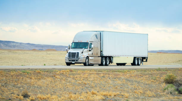 istock Long haul semi-truck driving on empty single line road in Utah, USA 1422062425