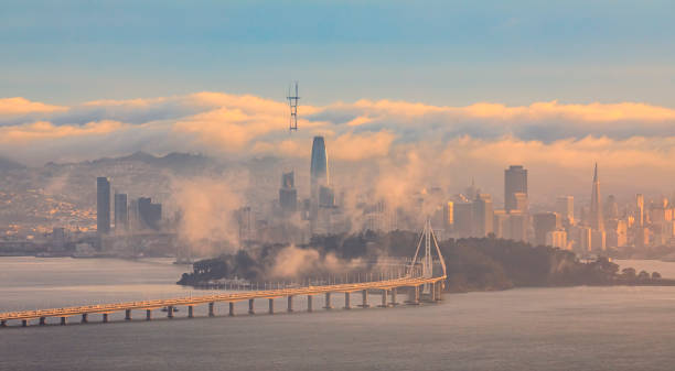 View from Grizzly Peak in Berkeley Hills onto Bay Bridge and San Francisco with Karl the fog enveloping the city at sunset View from Grizzly Peak in the Berkeley Hills onto Bay Bridge and San Francisco with Karl the fog enveloping the city at sunset. berkeley california stock pictures, royalty-free photos & images
