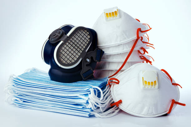 istock Stack of medical masks with respirator on white background 1422063359