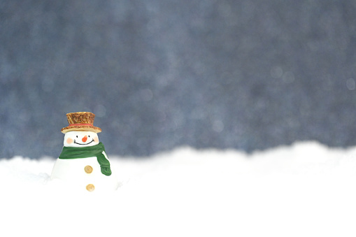 Snowman in the snow with gray background