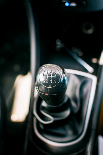 Gear lever of a vehicle. Close-up of a car gear lever, Close up of a car gear knob. Detail view of a vehicle transmission lever