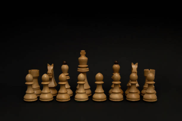 istock Chess pieces without queen on black background. 1422070668