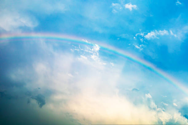 istock Rainbow cloud in contrast sky. Contrasting picture. Blurry image. 1422074461