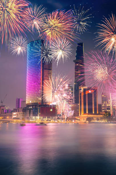 celebration. skyline with fireworks light up sky over business district in ho chi minh city ( saigon ), vietnam. beautiful night view cityscape. holidays, independence day, new year and tet holiday - laser firework display performance showing imagens e fotografias de stock