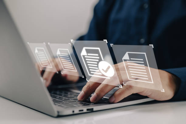 istock Laptop with virtual screen and document for paperless quality assurance and ERP online approval. 1422077434