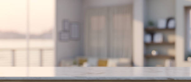 istock Mockup space on white marble tabletop over blurred modern living room in the background 1422084483