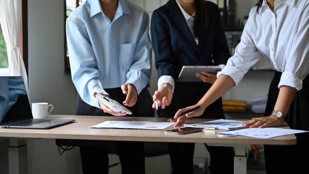 istock cropped shot, Professional Asian financial analysts working together 1422084874