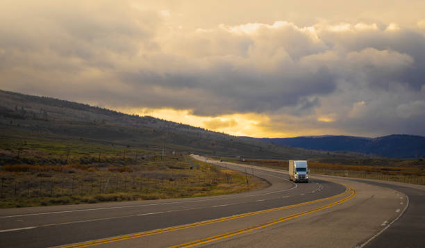 istock White semi transporting merchandising in Utah, USA at sunset 1422086184