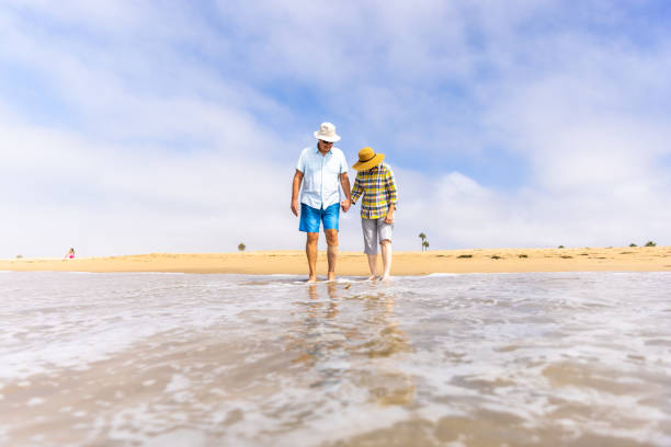 istock Couple Enjoying a Vacation Day at the Beach 1422087470